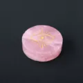 Natural rose quartz crystal disc with golden laser engraved mystical eye pattern for decor. - All-Seeing Eye Pattern