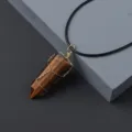 Detail shot of natural tiger's eye crystal hexagonal column pendant with gold wire wrap. - Tiger's Eye / Pendant
