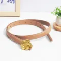 Close-up detail of the stylish women's leather belt featuring a luxury gold rose flower buckle. - Beige