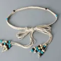 Detail view of bohemian braided rope belt, featuring natural wooden and turquoise beads. - White