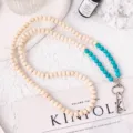 Beaded phone lanyard with natural wood and turquoise round beads for cross-body style. - Blue Turquoise