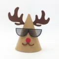 Closeup detail of kids cute felt reindeer Christmas party hat with funny shutter glasses. - Coffee Moose