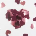 Close up view of heart confetti details, showing shiny rose gold and dark red paper pieces. - Rose Gold and Burgundy Hearts (Approx. 20g/Pack)