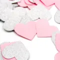 Close-up view of shimmering silver and pink heart confetti scattered for party decor. - Pink & Silver Hearts (Approx. 20g/Pack)