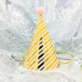Gold and white striped party hat closeup, pink pom pom, celebration accessory. - Diagonal Stripes on Pink (Pom-pom Ball)