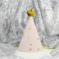 Close-up detail of cute pink cone birthday party hat with gold stars and sequin pom-pom. - Stars on Pink (Sequin Ball)