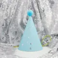 Adorable light blue birthday party hat with cute pom-pom and silver stars for kids celebration. - Light Blue Stars (Pom Poms)