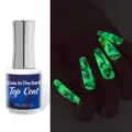 Detailed view of glow in the dark nail top coat bottle and fluorescent butterfly nail effect. - Transparent Luminous / 15ml