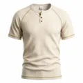Close-up of men's waffle knit short sleeve henley shirt with contrast stitching details. - Khaki