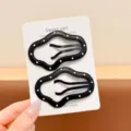 Close-up detail of black polka dot leather hair clips set, elegant chic side bang styling accessory. - All Black Cloud 2-Piece Set