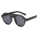 Lunettes de soleil rondes noires élégantes avec monture épaisse et protection UV. - Monture Noire Verres Gris