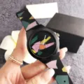 Detail view of the stylish silicone watch featuring a unique colorful geometric pattern design. - Black