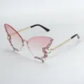 Close-up detail of trendy butterfly rimless sunglasses with pink gradient lenses and rhinestones. - Gradient Pink