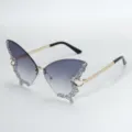Detailed view of trendy butterfly sunglasses with gradient lenses and sparkling rhinestones. - Gradient Grey