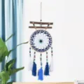 Handcrafted cotton dream catcher with wood sticks and blue tassels for boho room decor. - 9545C Tassel Dreamcatcher