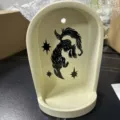 Resin arch niche wall altar with black mythical creature silhouette and star graphic decor. - Sirius