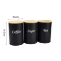 Set of 3 black metal kitchen storage canisters with bamboo lids for coffee, sugar and tea. - Round Black 3-Piece Set