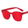 Adult one-piece frameless sunglasses with red transparent lenses for outdoor sun protection. - Red