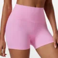 Detailed view of high-waisted pink yoga shorts featuring stretchy fabric for fitness workouts. - S / Bottoms / Vibrant Pink