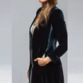 Close-up detail of women's dark velvet long coat with gold chain accessory stylish - Navy Blue