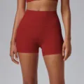 High-waisted red athletic yoga shorts, form-fitting design for gym, running, and pilates training. - Angola Red
