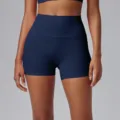 High-waisted athletic yoga shorts close-up view, dark blue activewear training apparel. - Navy Blue