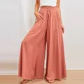 Vista dettagliata pantaloni larghi donna vita alta tinta unita con elastico in vita e tasche. - arancio-rosso