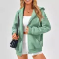 Detailed view of casual light green ribbed zip hoodie with hood, long sleeves and pockets. - S / Tops / Green