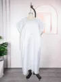 Detailed view of the white satin loose kaftan dress with exquisite chest embroidery features. - One Size / Dresses / White