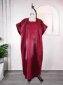 Detail view of the burgundy satin kaftan dress featuring an elegant square neckline and intricate embroidery. - One Size / Dresses / Burgundy