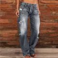 Close-up detail of women's washed distressed flare jeans featuring stylish ripped design. - S / Gray