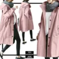 Detailed view of women's casual loose mid-length pink trench coat with hood and waist. - S / Pink