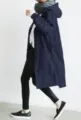 Detail shot of casual loose hooded long trench coat in dark blue, showcasing the fit and waist. - Navy Blue