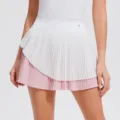 Detailed view of the pleated sports tennis skirt with pink and white layered design for active wear. - S / Pink