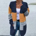 Detailed view of the stylish color block knit cardigan featuring long sleeves and pockets. - Blue Orange