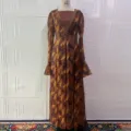 Detailed shot of a brown long-sleeve maxi dress with rhinestone V-neck and geometric print. - S / Dresses / Floral Print Dresses