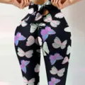 Close-up detail of women high waist peach hip yoga pants with cute bow and colorful butterfly print. - S / Bottoms / Colorful Butterfly Print (2)