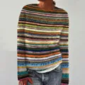 Detailed view of the colorful striped knitted sweater, showing soft texture and comfortable fit. - S / Coffee