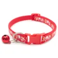 Detailed view of the red pet collar featuring bubble patterns, quick-release buckle and bell. - Red