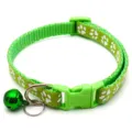 Close-up detail of green pet collar with white paw prints, buckle, and metal bell. - Light Green