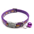 Close-up view of a purple woven pet collar with cute cartoon patterns, a bell and buckle. - Purple