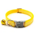 Detailed close-up of yellow plaid pet collar with grey plastic buckle and gold bell. - Yellow