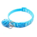 Blue pet collar detail view, featuring cute white paw print pattern, metal D-ring and bell. - Lake Blue