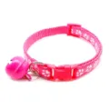 Detailed view of pink pet collar featuring white paw print design and attached bell. - Rose Red