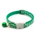 Green cracked pet collar detail, nylon strap with plastic buckle, metal D-ring and bell. - Green