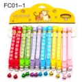Colorful pet collar detail shot, fabric strap with cute paw prints and a ringing bell. - FC01-1