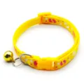 Yellow pet collar with cute paw print patterns, safety plastic buckle, and a crisp golden bell. - Yellow