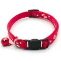 Red paw print pet collar with bell, adjustable strap and buckle for cats and dogs detail view. - Red