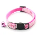 Pink footprint pet collar with bell and buckle for cats and dogs, detailed pet accessory view. - Pink