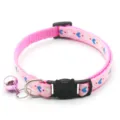 Close-up of pink pet cat collar detail with cute heart print and black safety buckle and bell. - Pink